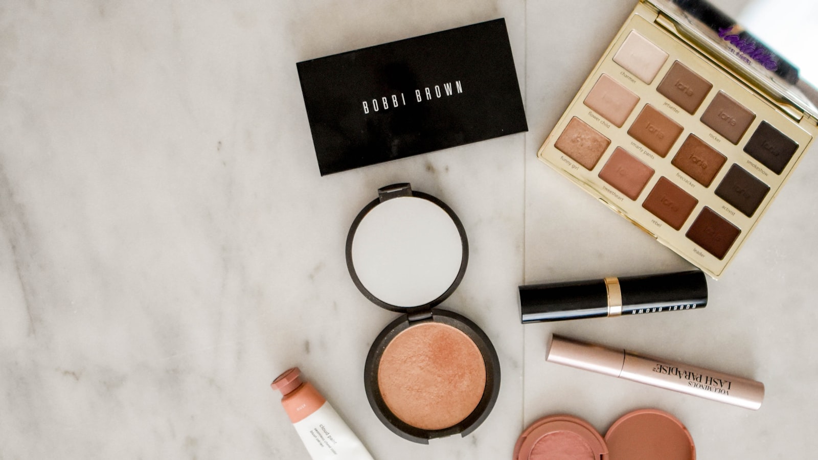A soft morning vanity with a few simple makeup products laid out neatly
